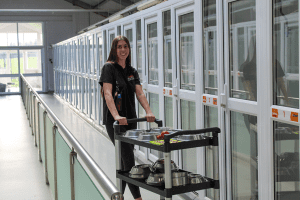 DSPCA Pet hotel staff member doing the morning food round for the happy residents